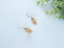 14k gold kettlebell earrings given as a mother's day gift to a bodybuilder